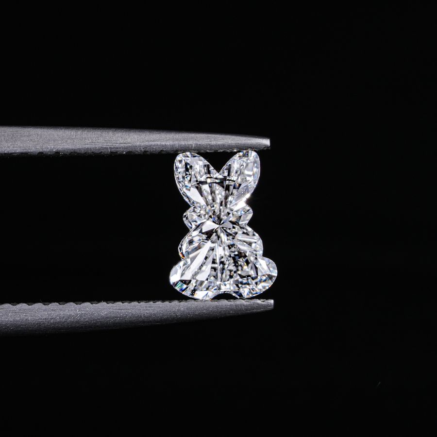 A fancy-cut diamond held in tweezers
