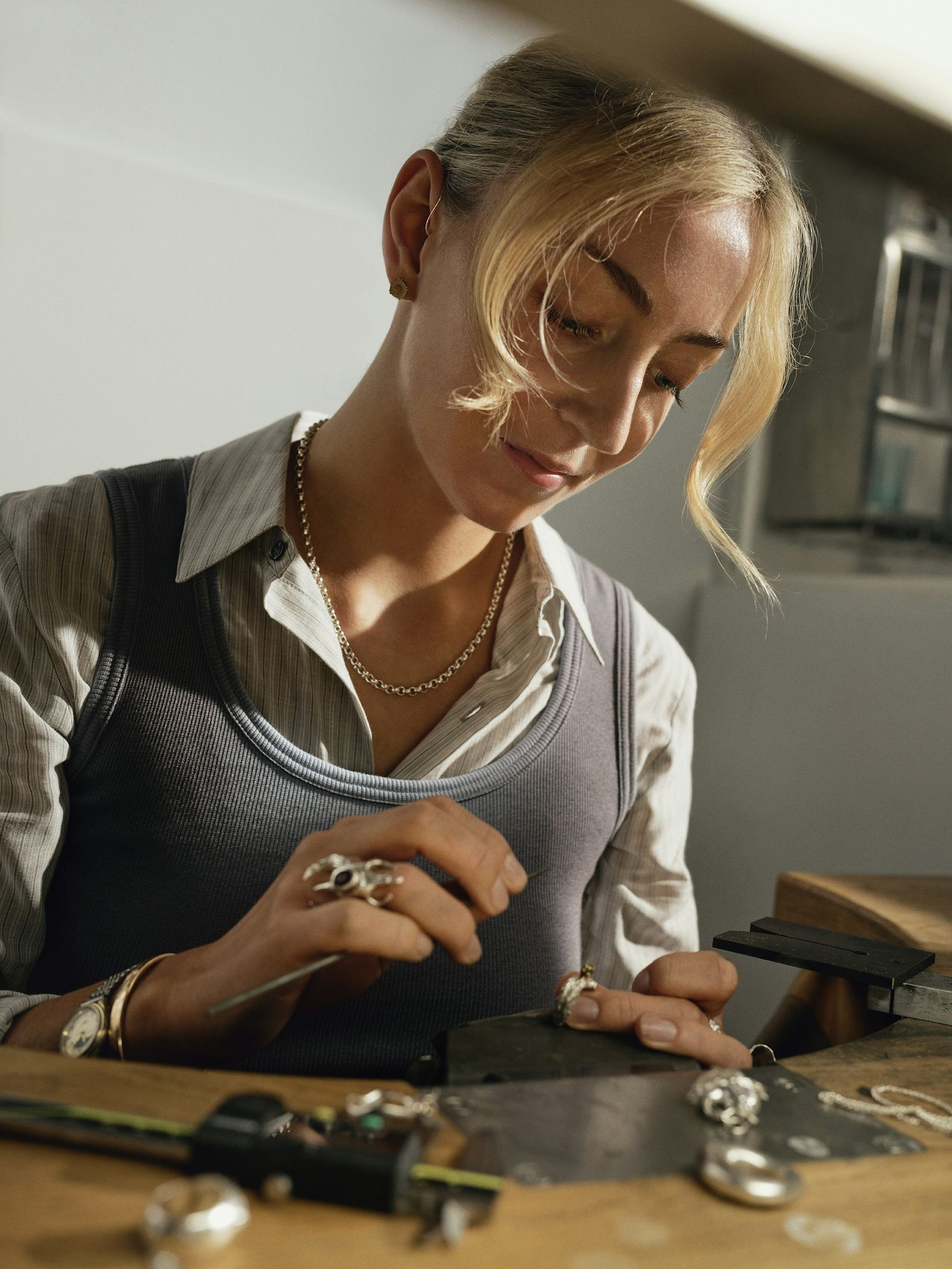 A jeweller working carefully at a jeweller's workbench
